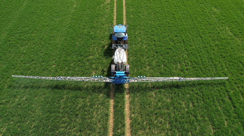 CHCNAV SprayX100 intelligent spraying system on a tractor sprayer in a field