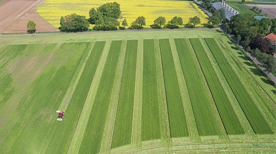 CHCNAV NX510 auto-steering system mounted on the cabin of a tractor in the field